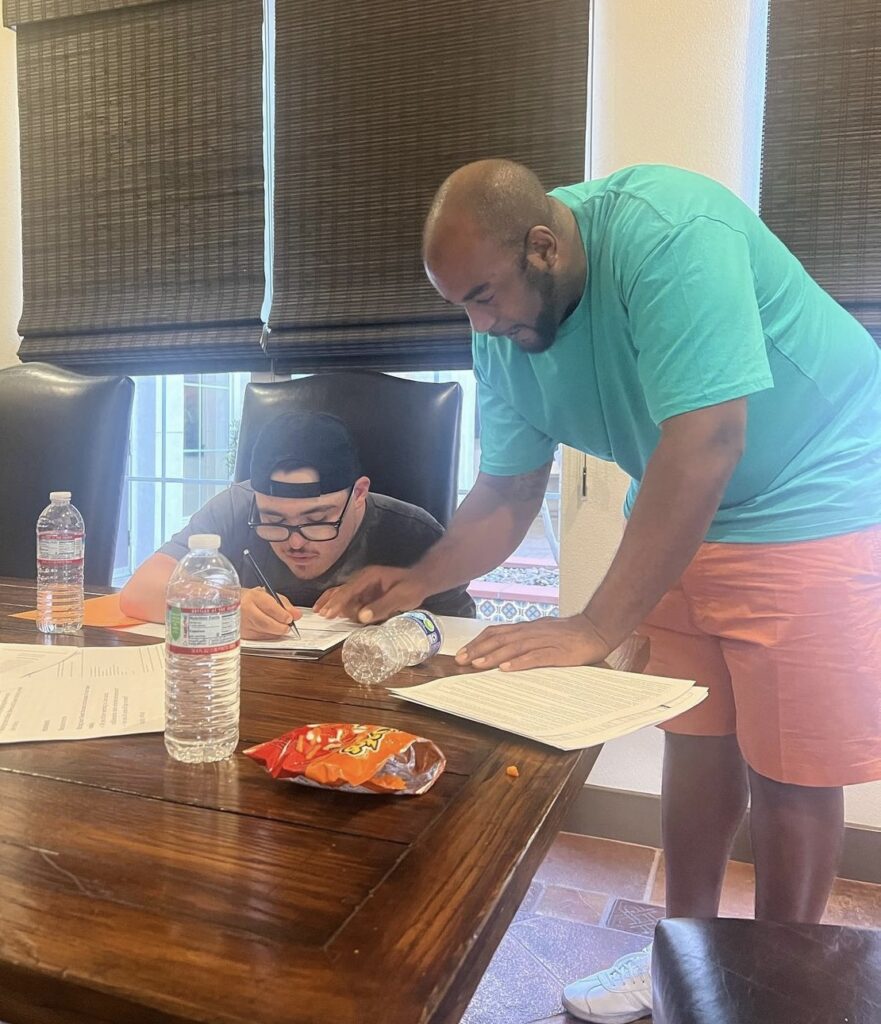 man assisting another man with application