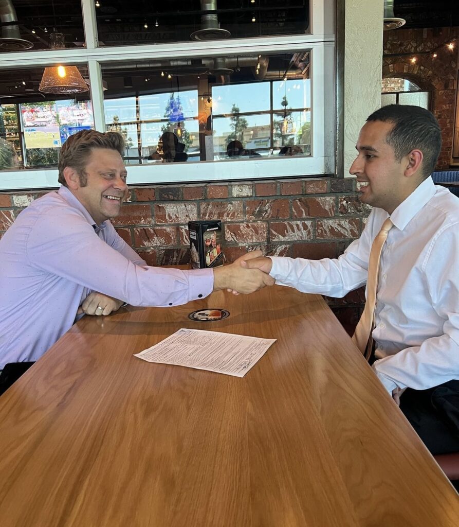 to men shaking hands at interview